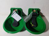 pair of green water fountains with tags attached to them on a table