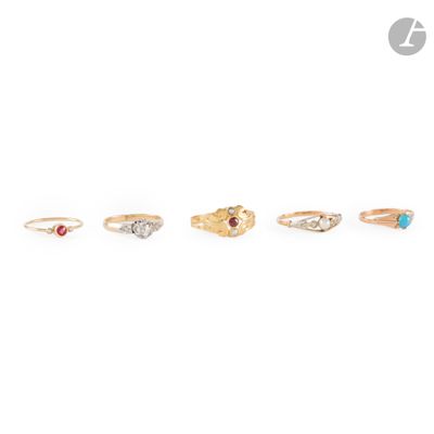 a set of five gold rings with different colored stones