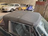 a car that is parked in a garage next to other cars