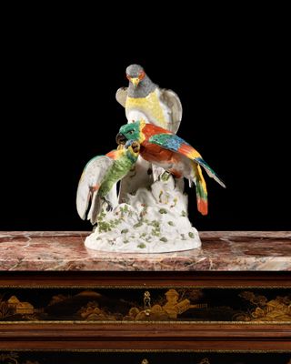 a figurine of two birds sitting on top of a table