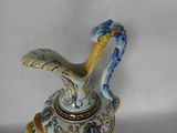 a blue and white vase with a bird on top of it