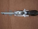 a gun that is sitting on a brown surface