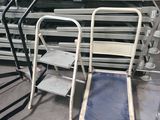 many chairs and a hand truck in a warehouse