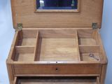a small wooden box with a mirror on top of it