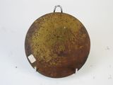 an old rusty metal plate with a tag hanging from it ' s side