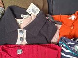 a pile of clothes that is sitting on the floor