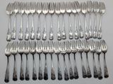 a lot of forks and spoons that are on the table