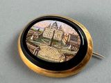a picture of a pin with a picture of a city
