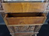 a wooden cabinet with a mirror on top of it