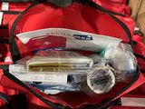 a red duffel bag filled with medical supplies