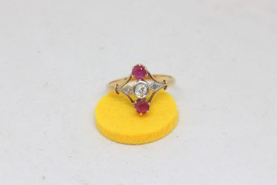 an image of a diamond and ruby ring sitting on a yellow sponge
