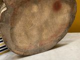 a person that is holding a wooden object on a table