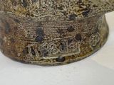 a close up of a brown vase with writing on it