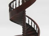 a close up of a wooden spiral staircase on a white background