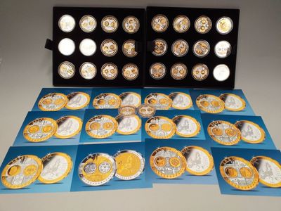 several different types of gold and silver coins in a display case