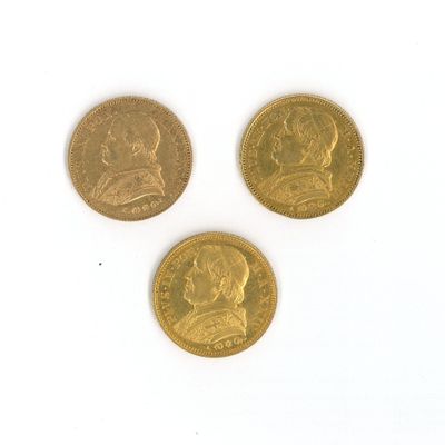 three different types of gold coins on a white surface