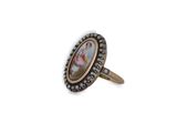 a close up of a ring with a picture of a woman on it