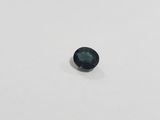 a close up of a black diamond on a white surface