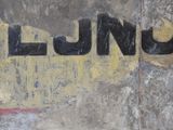 a yellow and black sign on the side of a building
