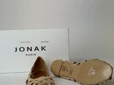 the shoes are on a white surface next to a box