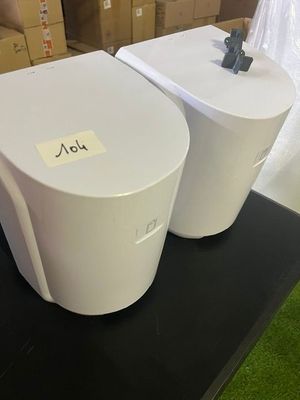 two toilets sitting on a black table in a room