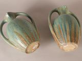 two vases sitting next to each other on a table