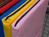 a shopping cart filled with lots of different colored bags