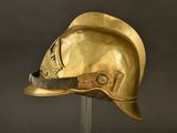 gold helmet on a stand with a black background