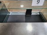 a glass display case with a phone in it