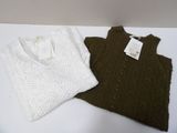 two sweaters that are on a white table