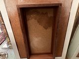 a fire place in the corner of a room that is being remodeled