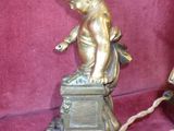brass figurines of a boy and a girl on a pedestal
