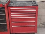 une boîte à outils rouge avec un couvercle noir, une boîte à outils rouge avec un couvercle noir et une boîte à outils rouge avec un couvercle noir