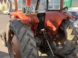 a tractor that is parked on the side of the road
