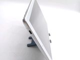 a tablet computer sitting on a stand on a white surface