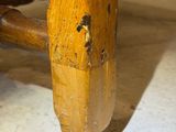 a close up of a wooden chair with a wooden seat
