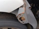 a close up of a car ' s front wheel with a flat tire