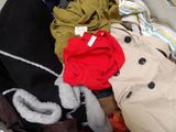 a pile of clothes that is sitting in a suitcase
