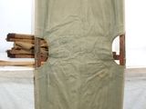 a chair with a sheet covering it in front of a window