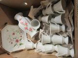 a lot of cups and saucers in a box