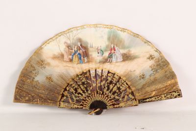 a fan with a painting on it sitting on a table