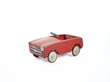 a red toy car that is sitting on a white surface