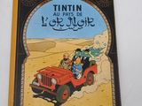 an old children ' s book about the adventures of tintin and his jeep
