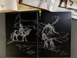a book with a drawing of a man on a horse and a drawing of a man on a horse