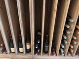 many bottles of wine in a wooden wine rack