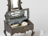 a small vanity with a mirror on top of it