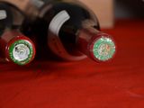 two bottles of wine sitting on a red table