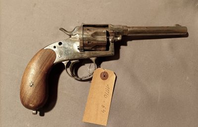 a gun that is on a table with a tag on it