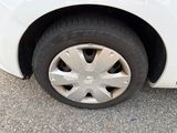 a white car with a flat tire on the street