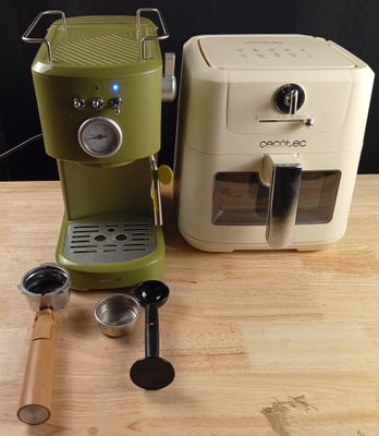 two coffee machines sitting on a table next to each other